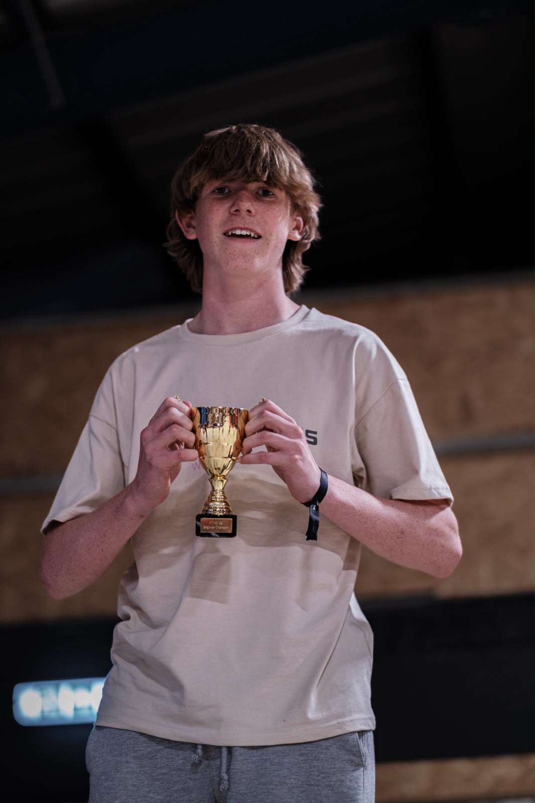 Beginner champion holding trophy